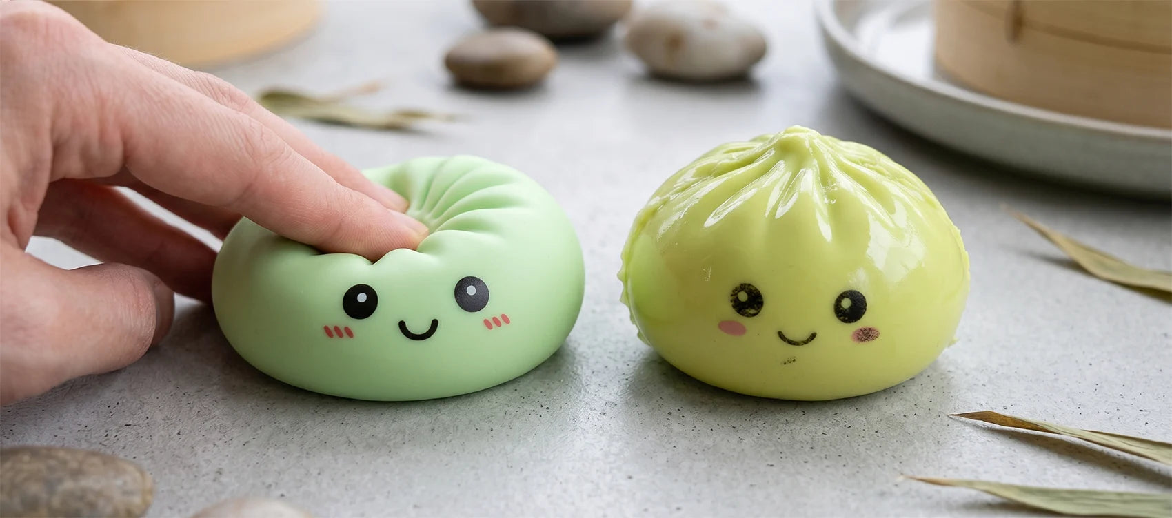 Side-by-side comparison of a genuine matte green squishy dumpling being squeezed versus a stiff shiny knockoff